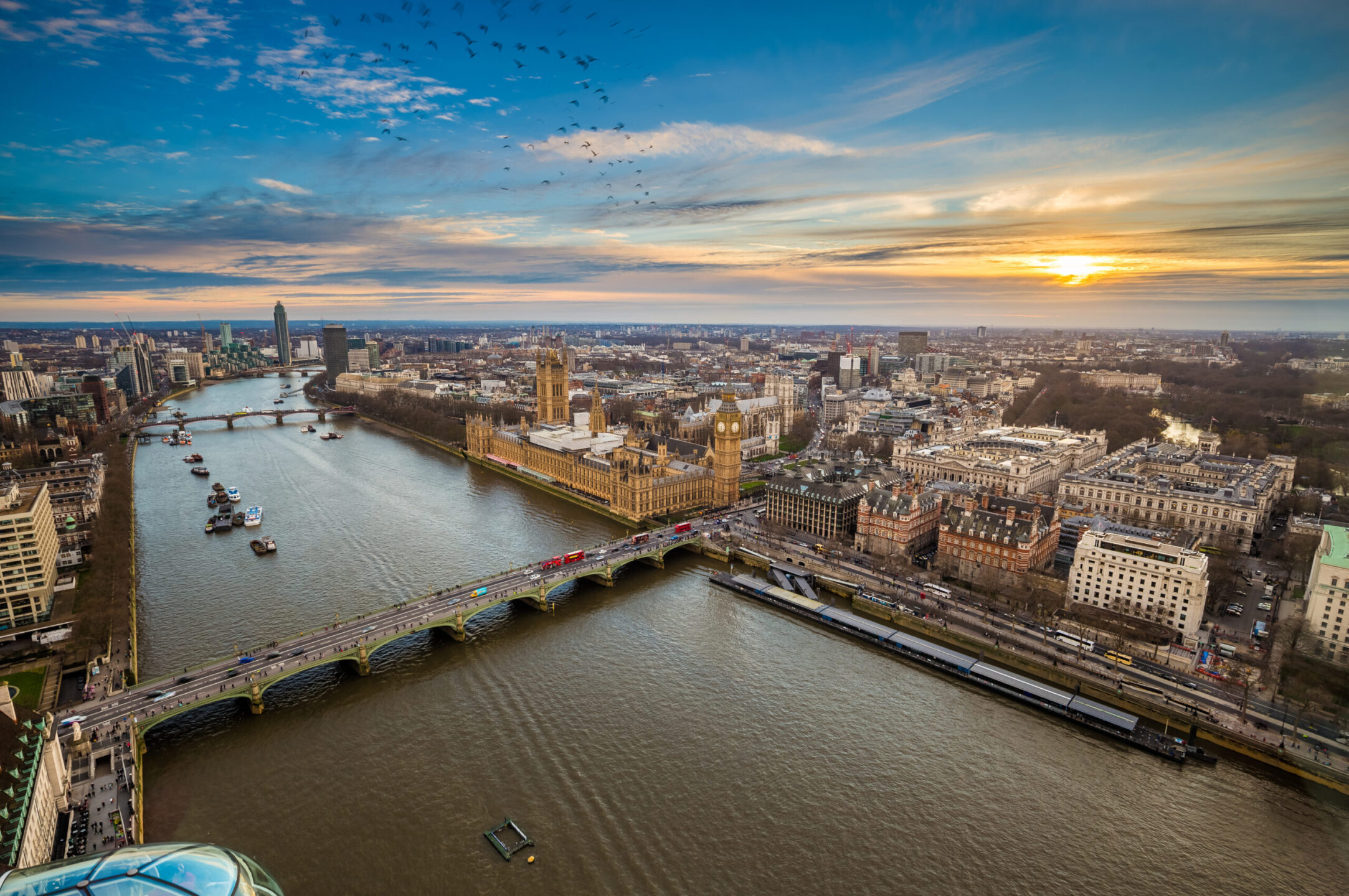 London, England - Aerial view of central London, with Big Ben, Houses of Parliament, Westminster Bridge, Lambeth Bridge at sunset with flying birds